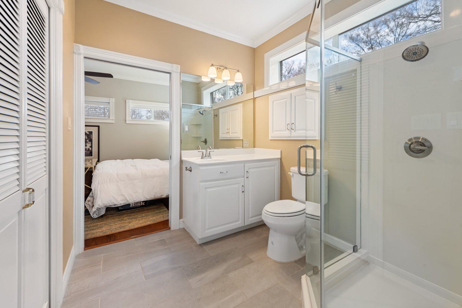 Downstairs full bath with a glass shower, connected to the guest bedroom