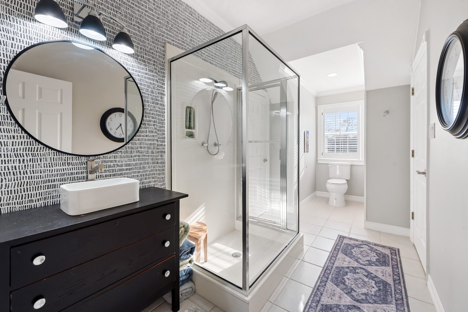 Upstairs bathroom with a glass shower, vessel sink, and window