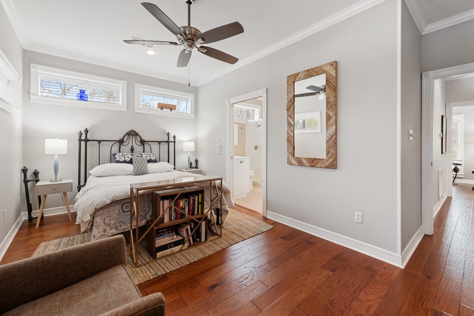 Downstairs bedroom with an iron bed and an en-suite bath