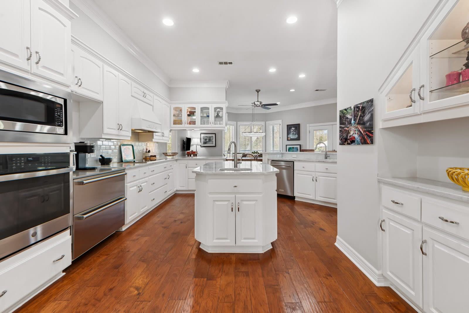 Chef's kitchen with marble counters, stainless appliances, and a large island