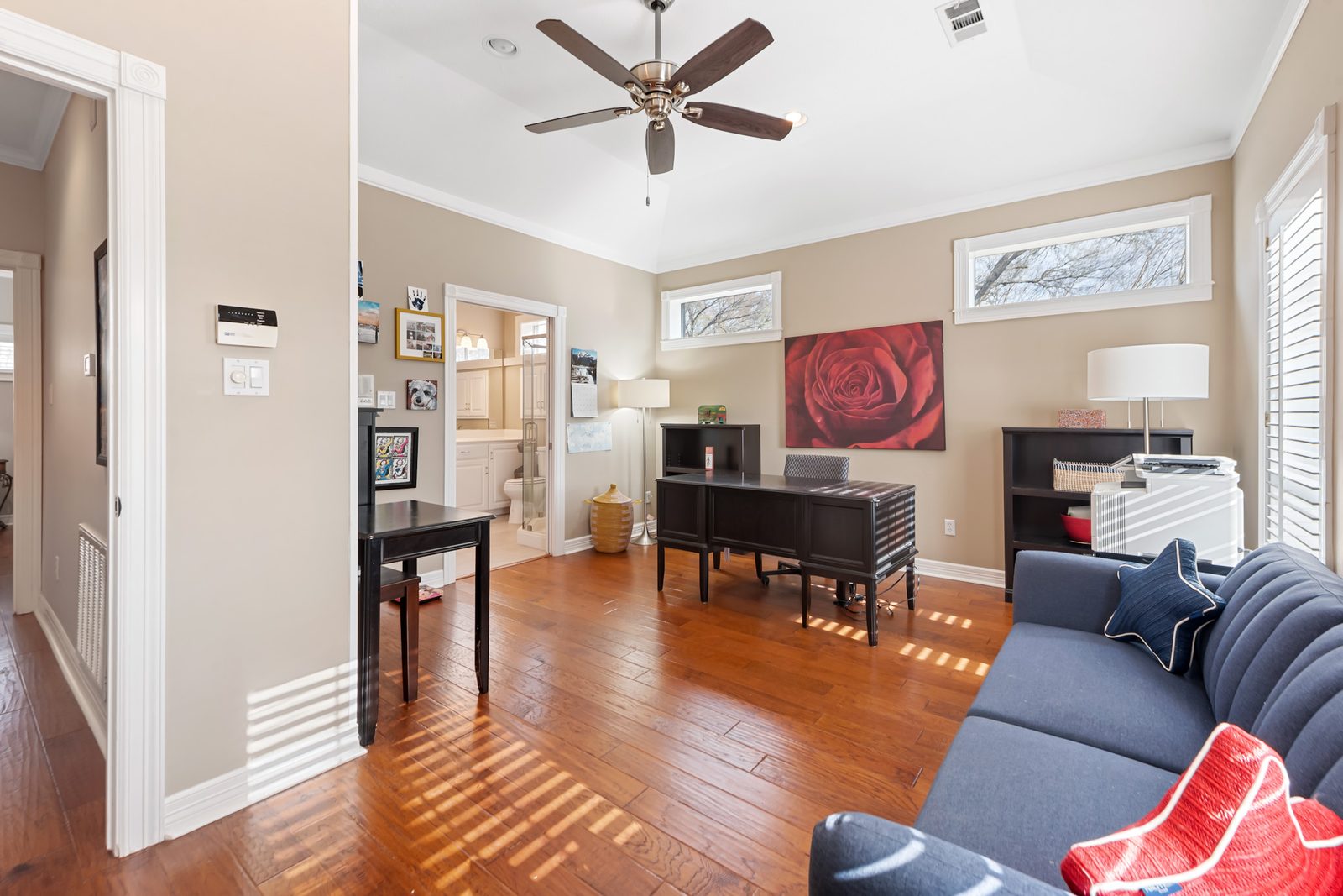 Flex office with an executive desk, sofa, and a connected bathroom
